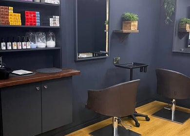 Modern styling chairs at Bassu Wellness Salon & Store in Morpeth, England, GB, showcasing a sleek interior.