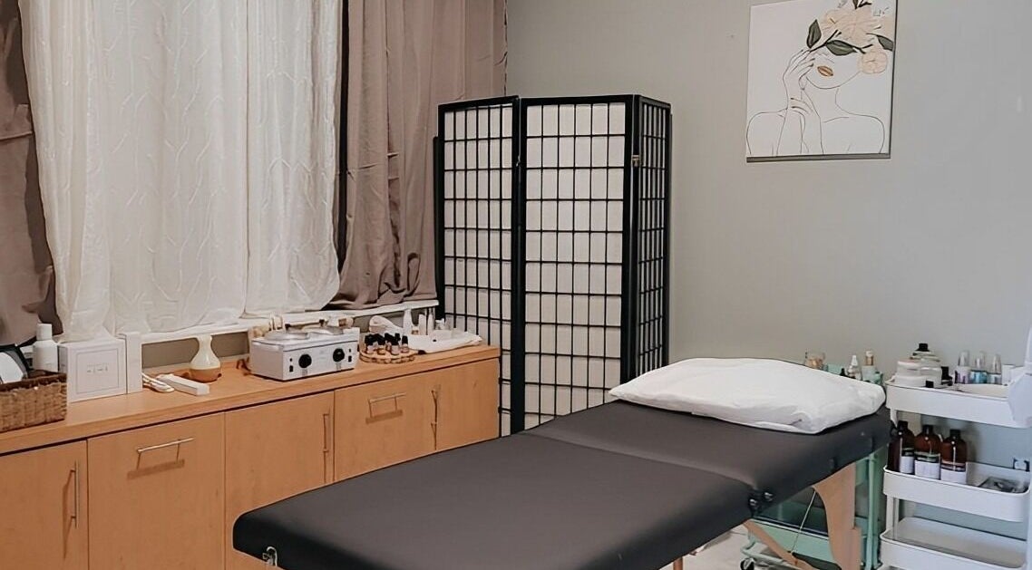 Relaxing spa room at The Berford St. Collaborative, Wiarton, Ontario, CA. Features massage bed and elegant decor.