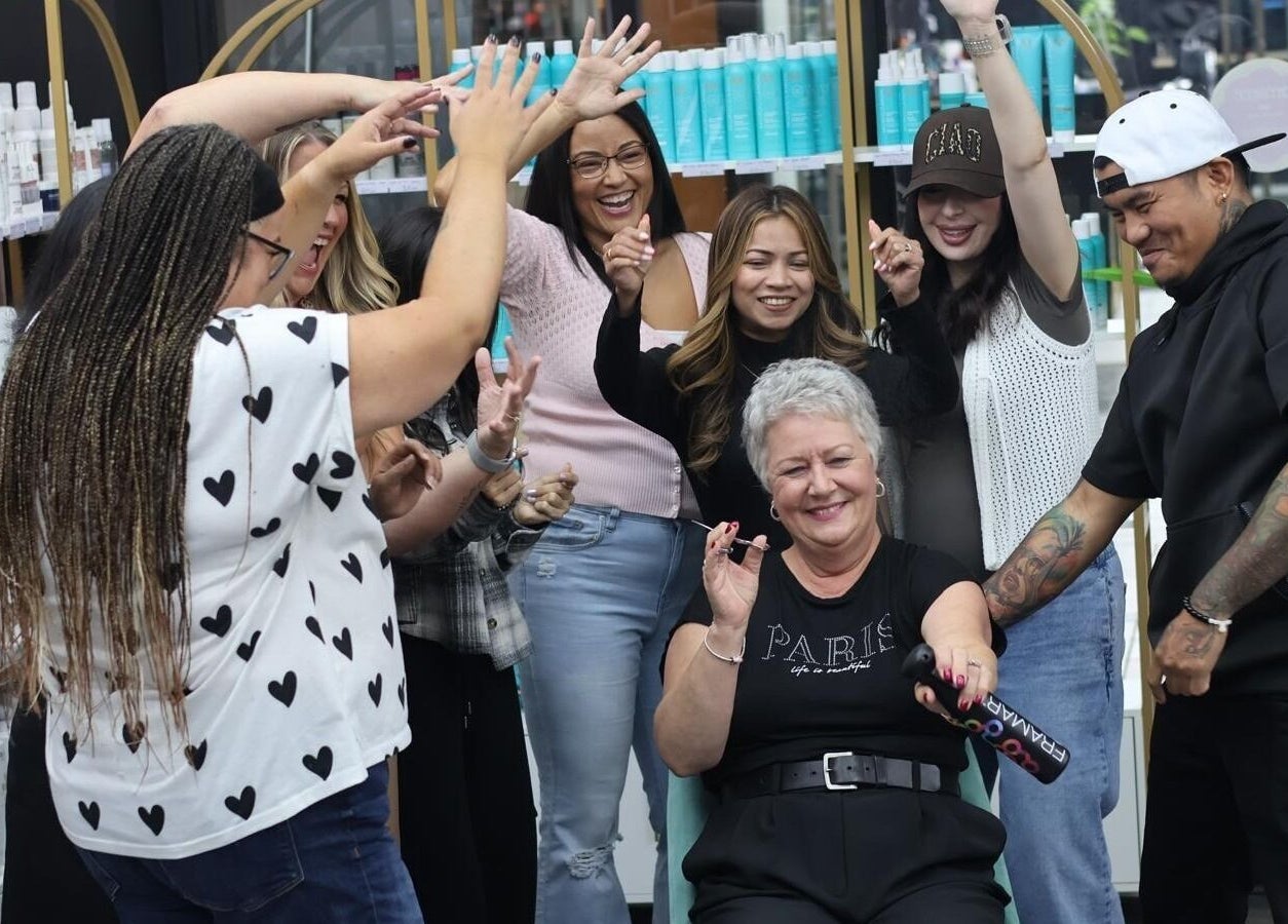 Happy group celebrating at Bedford Sunnyside Mall, Bedford, Nova Scotia, CA with beauty products behind them.