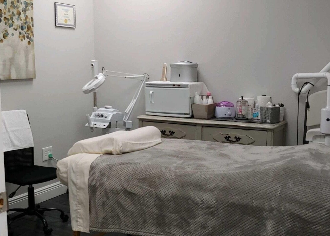 A cozy treatment room at Tanz Spa, Deltona, Florida, US, featuring a massage bed and beauty equipment.