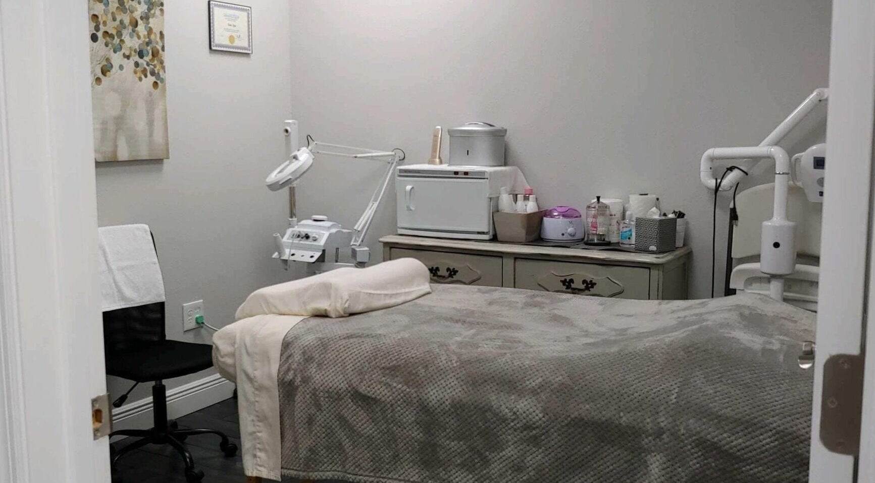 A cozy treatment room at Tanz Spa, Deltona, Florida, US, featuring a massage bed and beauty equipment.