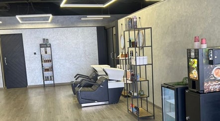 Modern interior of Retro Grooming Lounge for Men, Umm Al Quwain, AE with sleek wash stations and products.
