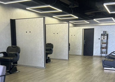 Stylish interior of Retro Grooming Lounge for Men in Umm Al Quwain, AE with sleek barber chairs.