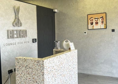 Reception area at Retro Grooming Lounge for Men, Umm Al Quwain, AE with modern decor and welcoming vibe.
