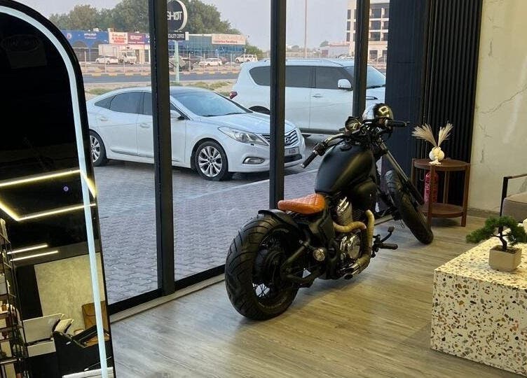 Interior of Retro Grooming Lounge for Men in Umm Al Quwain, AE featuring motorcycle and modern decor.