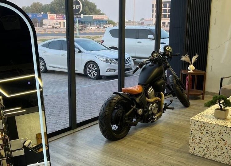 Interior of Retro Grooming Lounge for Men in Umm Al Quwain, AE featuring motorcycle and modern decor.
