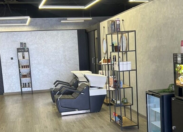 Modern interior of Retro Grooming Lounge for Men, Umm Al Quwain, AE with sleek chairs and shelves.