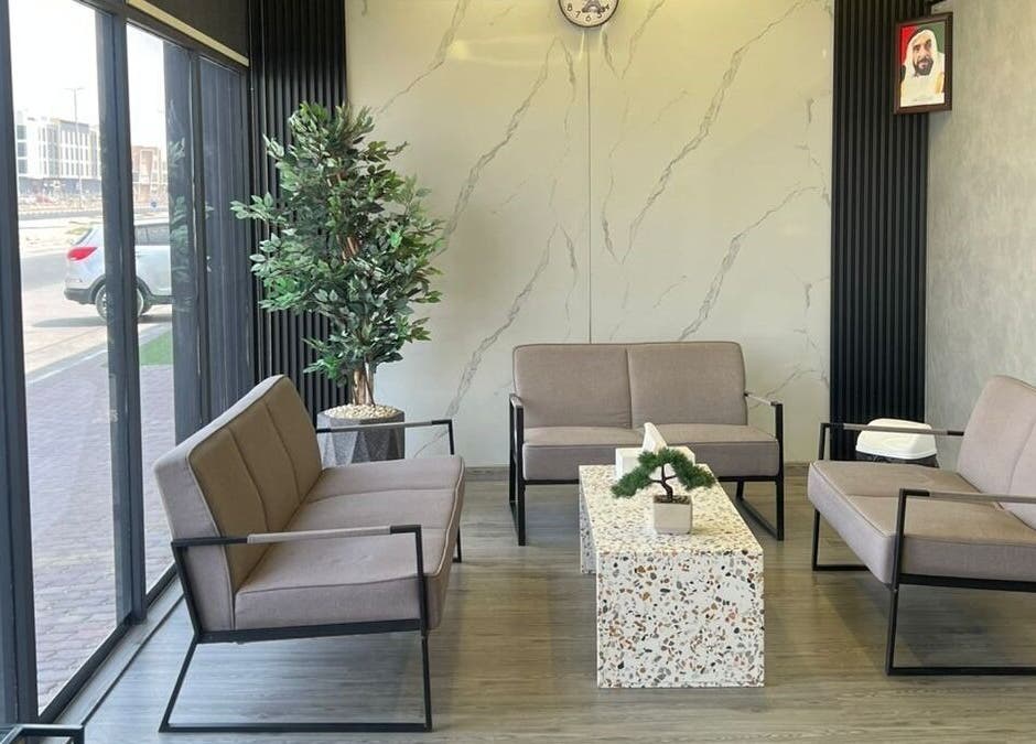Stylish waiting area at Retro Grooming Lounge for Men, Umm Al Quwain, AE with modern seating and decor.