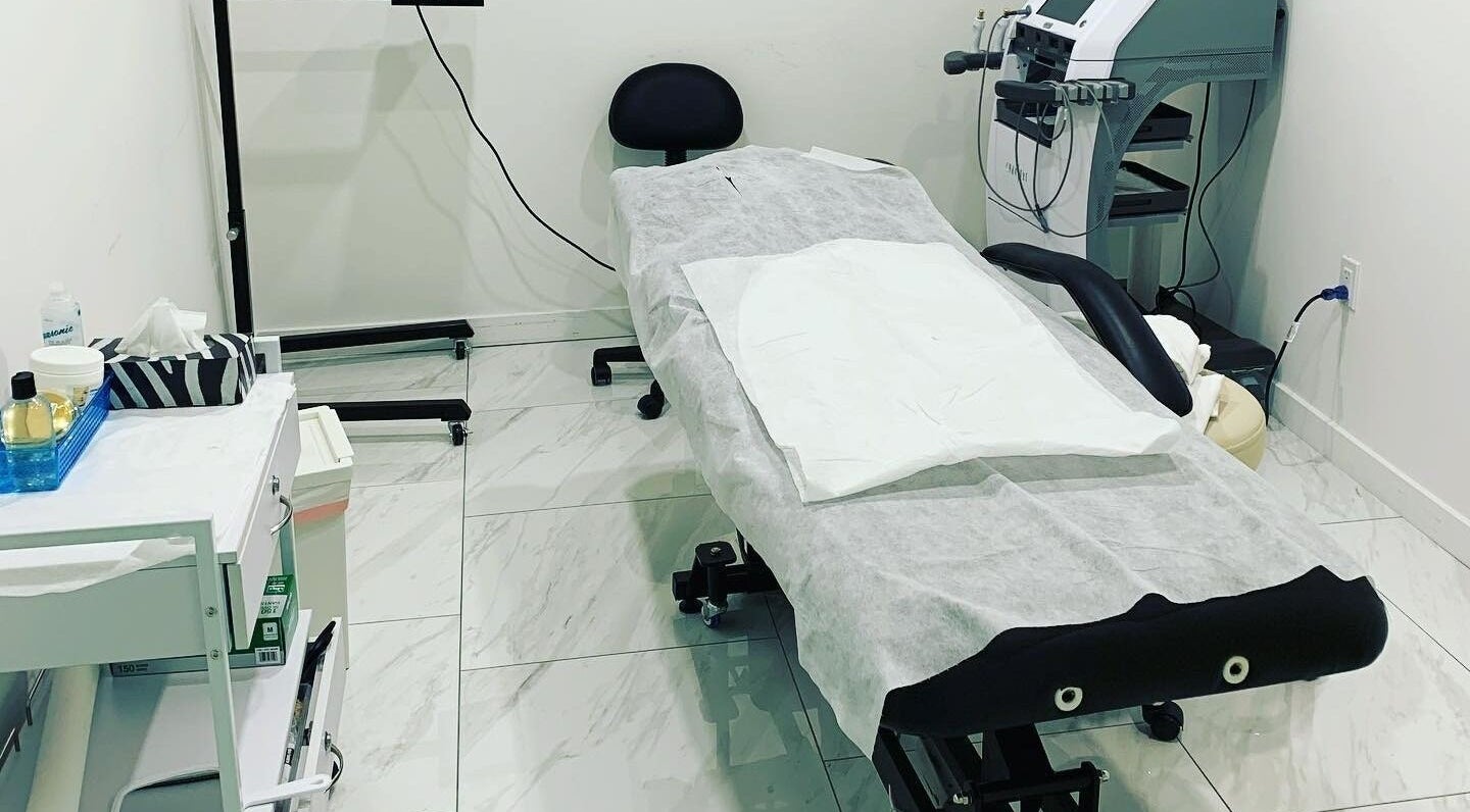 A modern treatment room at Imaan's Studio Ltd. in London, Ontario, CA, showcasing elegant equipment setup.