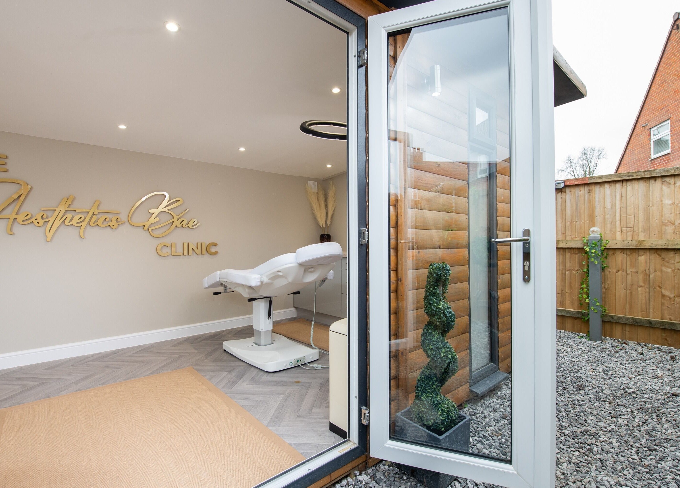 Open doors to a treatment room at The Aesthetics Bae Clinic - Winchester, offering a welcoming ambiance in Winchester, England, GB.