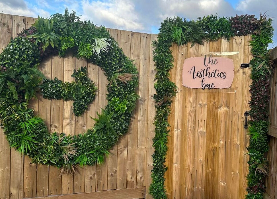 Entrance of The Aesthetics Bae Clinic - Winchester adorned with lush greenery, Winchester, England, GB.