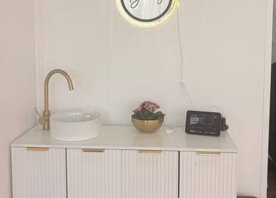 Minimalist washbasin with gold accents at Bare Beauty, Stafford, England, GB, embodying elegance and style.