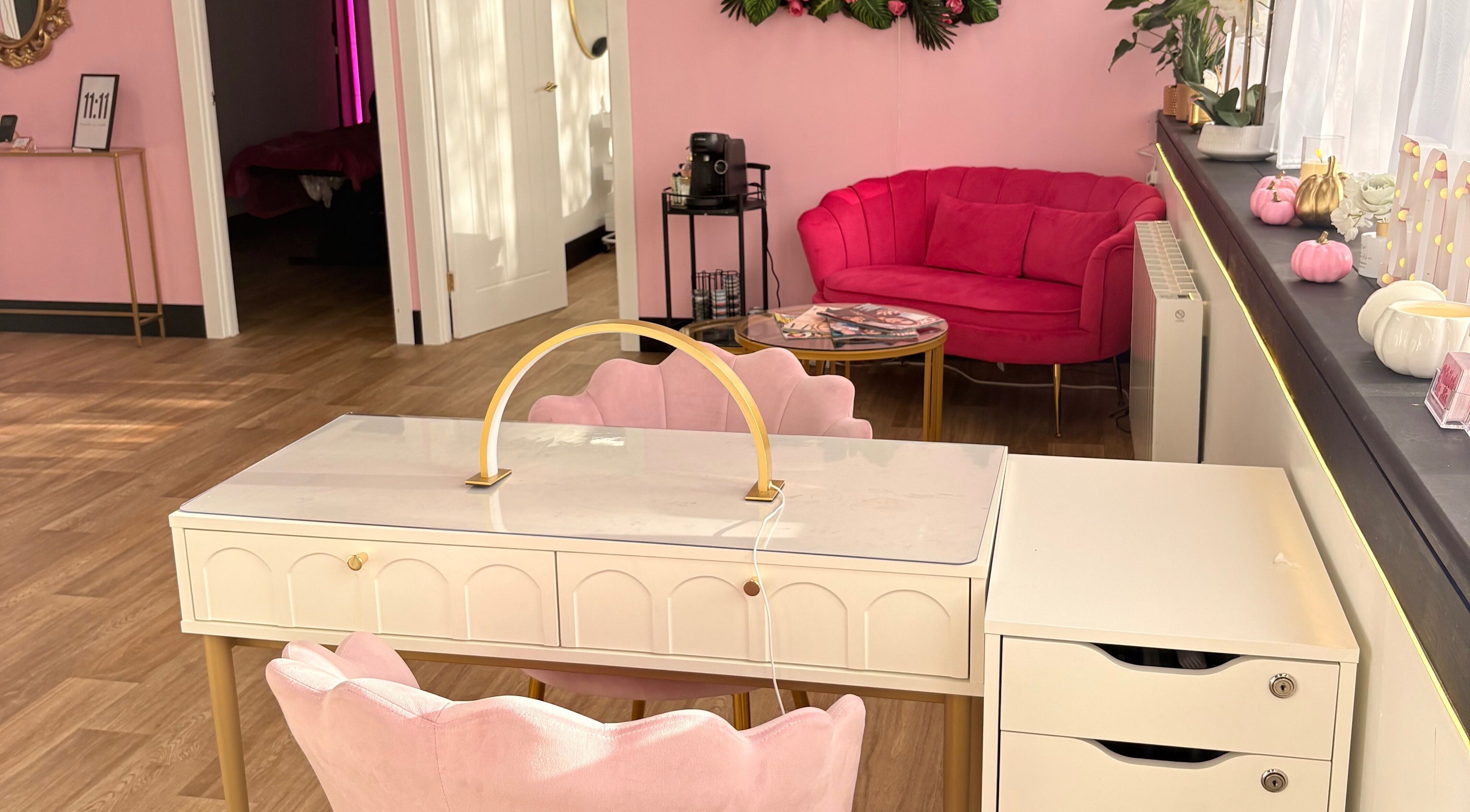 Elegant pink interior at Bare Beauty in Stafford, England, GB, showcasing chic furniture and stylish decor.