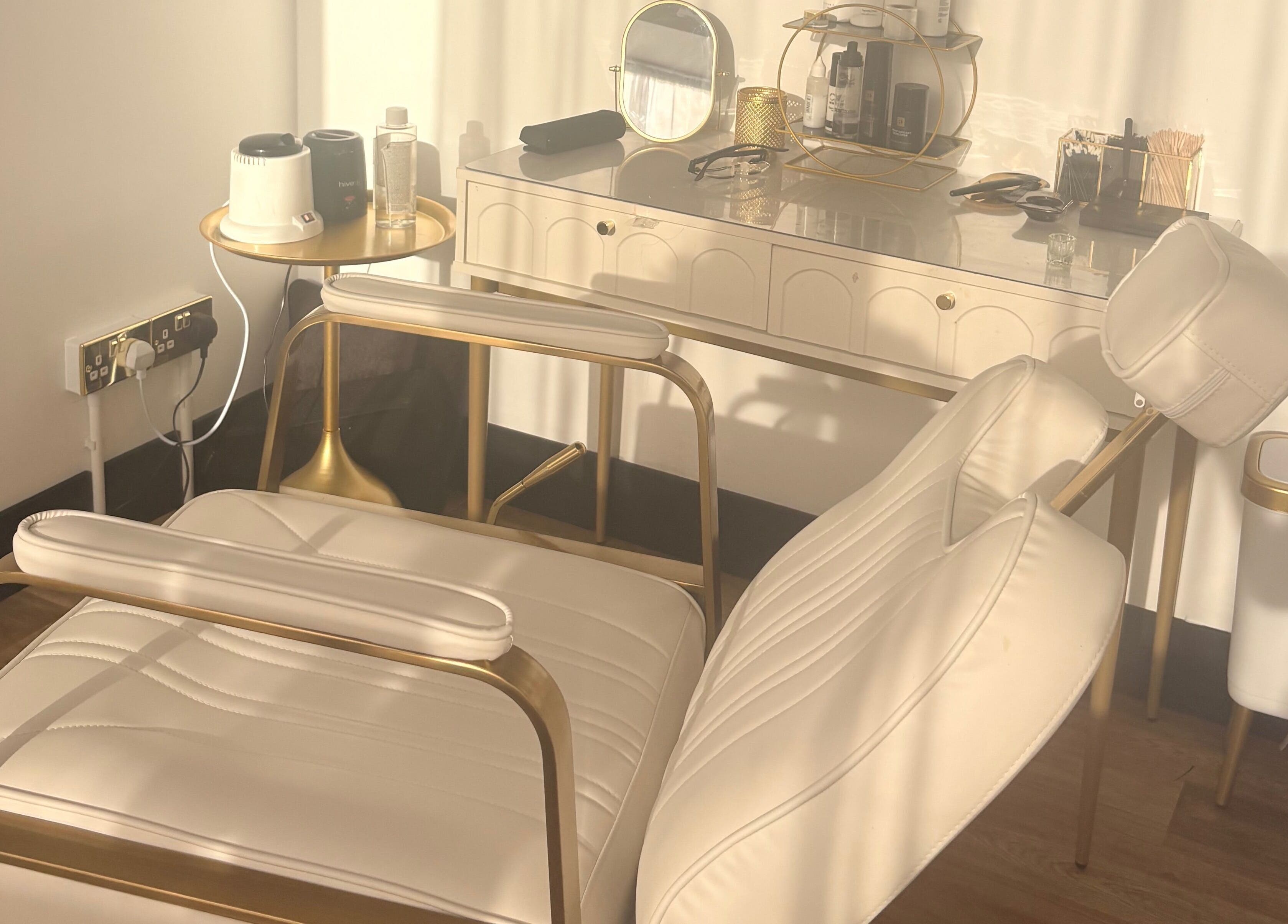 Elegant treatment chair at Bare Beauty, Stafford, England, GB, bathed in soft light for a relaxing experience.