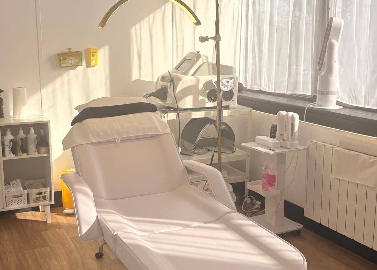 Cozy treatment room at Bare Beauty, Stafford, England, GB, featuring a plush reclining chair and modern equipment.
