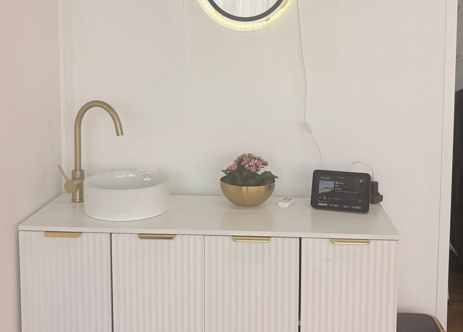 Modern vanity with sink and mirror at Bare Beauty, Stafford, England, GB.