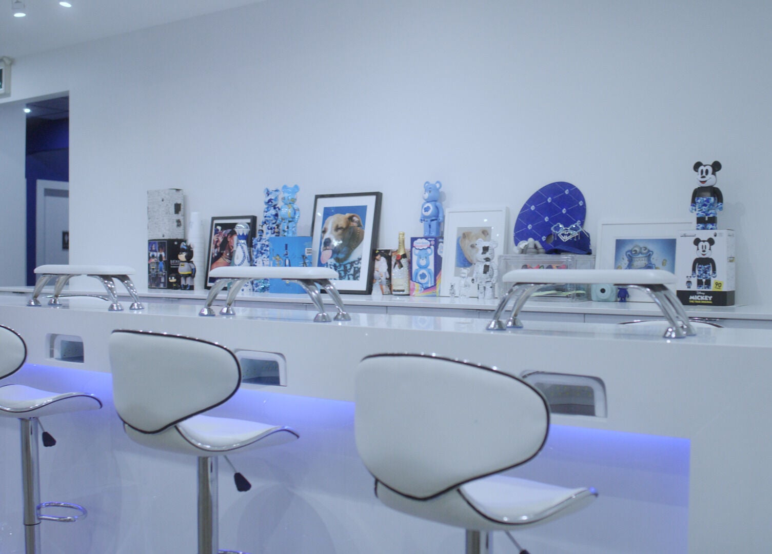 Modern nail station at Classy Claws, Vancouver, British Columbia, CA, featuring sleek white decor and art pieces.