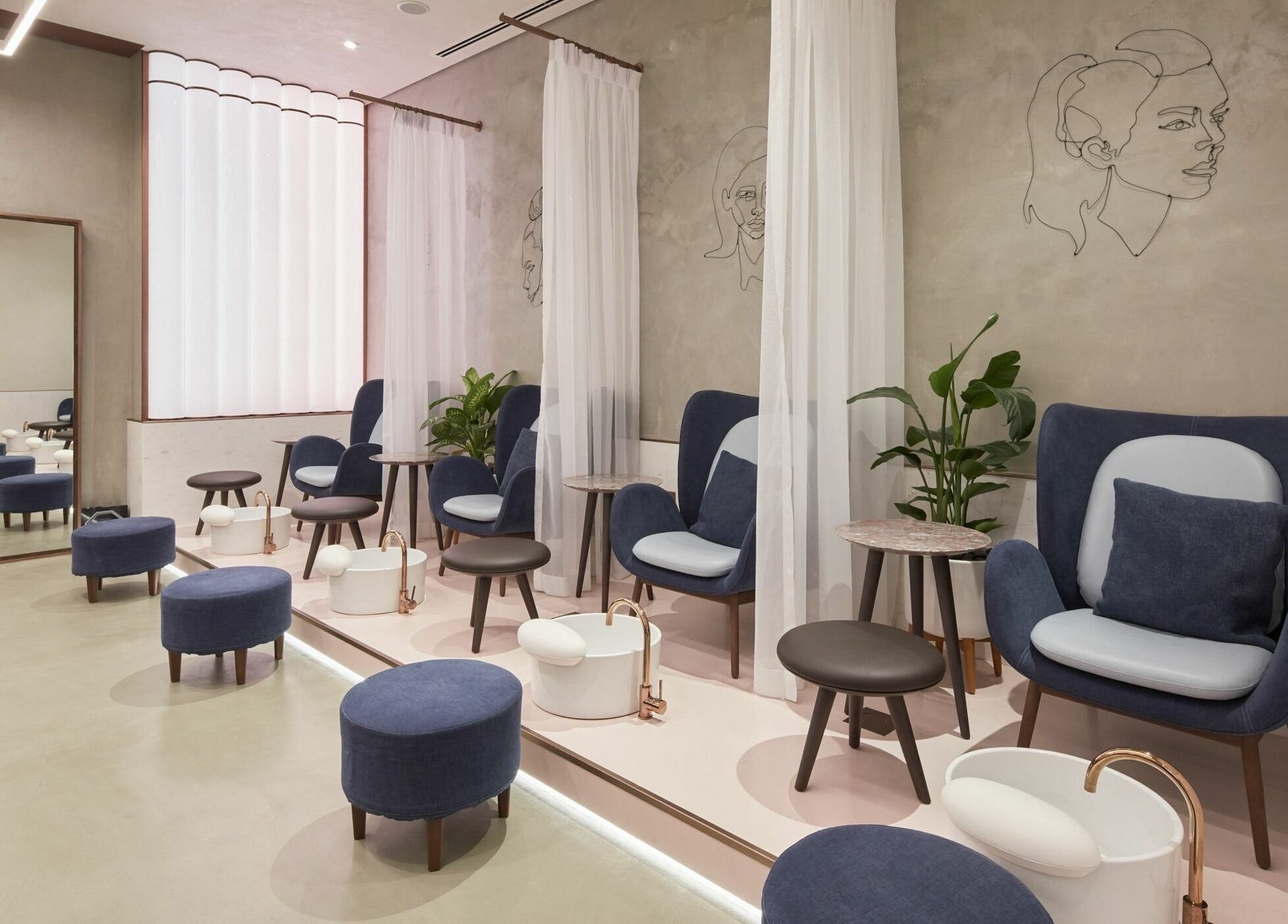 Luxurious pedicure lounge at Rose Poudre Beauty Bar, Abu Dhabi, AE, with plush seating and modern decor.
