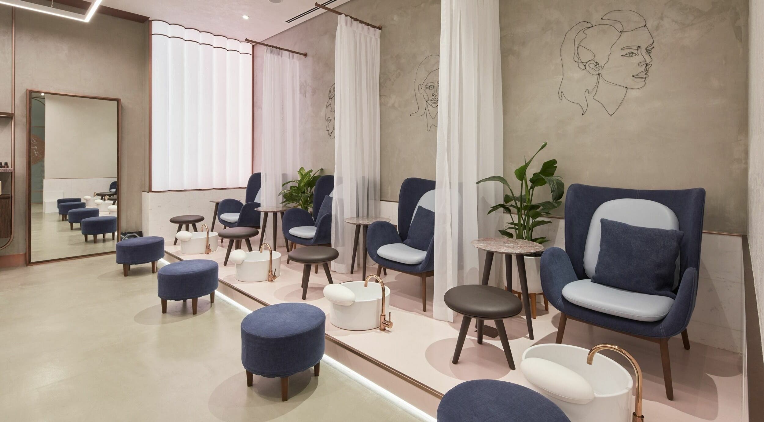 Luxurious pedicure lounge at Rose Poudre Beauty Bar, Abu Dhabi, AE, with plush seating and modern decor.