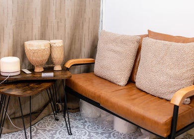 Comfortable seating area at Studio Leme - Male Massage & Spa, London, England, GB, with warm tones and decor.