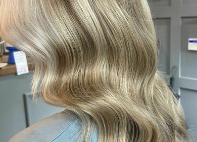 Elegant blonde waves styled at The Hair Cabin, Cambridge, England, GB.