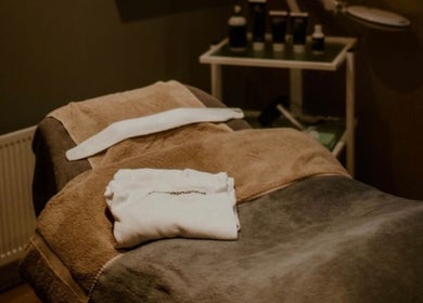 Cozy spa bed at Victoria's Health and Beauty, Lurgan, Northern Ireland, GB, with soft towels and tranquil ambiance.