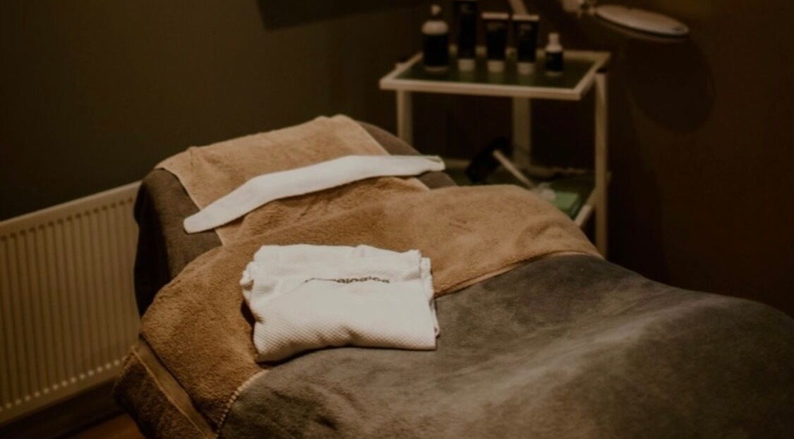 Cozy spa bed at Victoria's Health and Beauty, Lurgan, Northern Ireland, GB, with soft towels and tranquil ambiance.