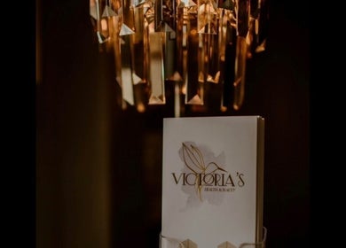 Chic chandelier and Victoria's Health and Beauty brochure in Lurgan, Northern Ireland, GB create an elegant ambiance.
