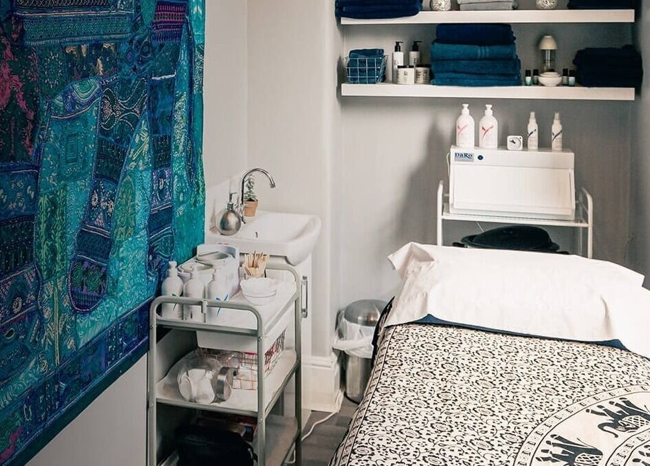 Serene treatment room at Jonathan Ditton salons in Emsworth, England, GB, featuring blue decor and cozy ambiance.