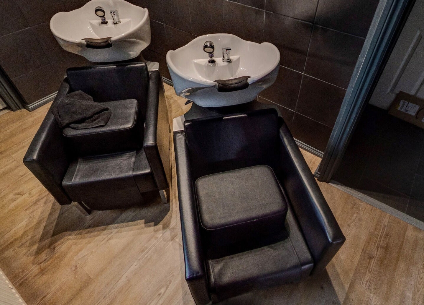 Wash stations at Jonathan Ditton salons in Emsworth, England, GB, showcasing modern chairs and sinks.
