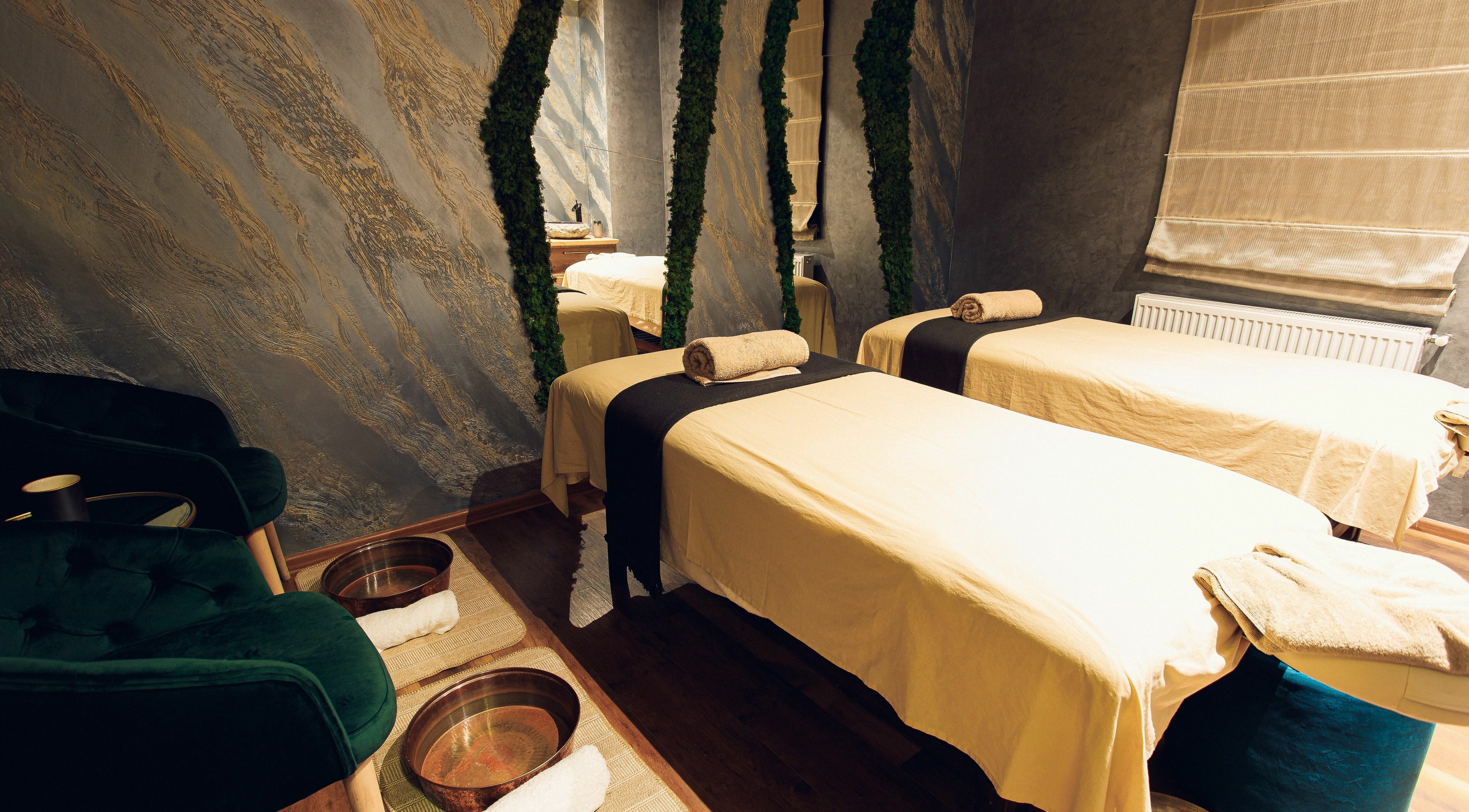 Relaxing treatment room at Adara Spa, București, București, RO, featuring two massage tables and elegant decor.