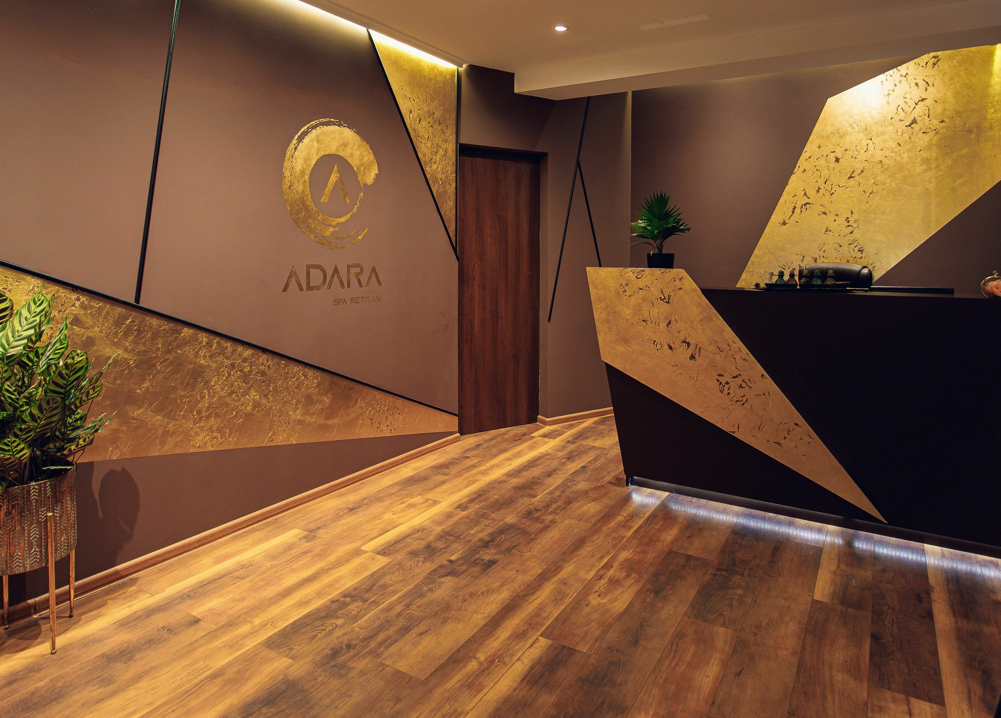 Luxurious reception area of Adara Spa in București, București, RO with golden accents and warm lighting.