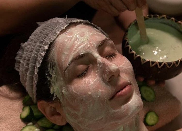 Woman indulging in a soothing facial at Adara Spa, București, București, RO, with green face mask.