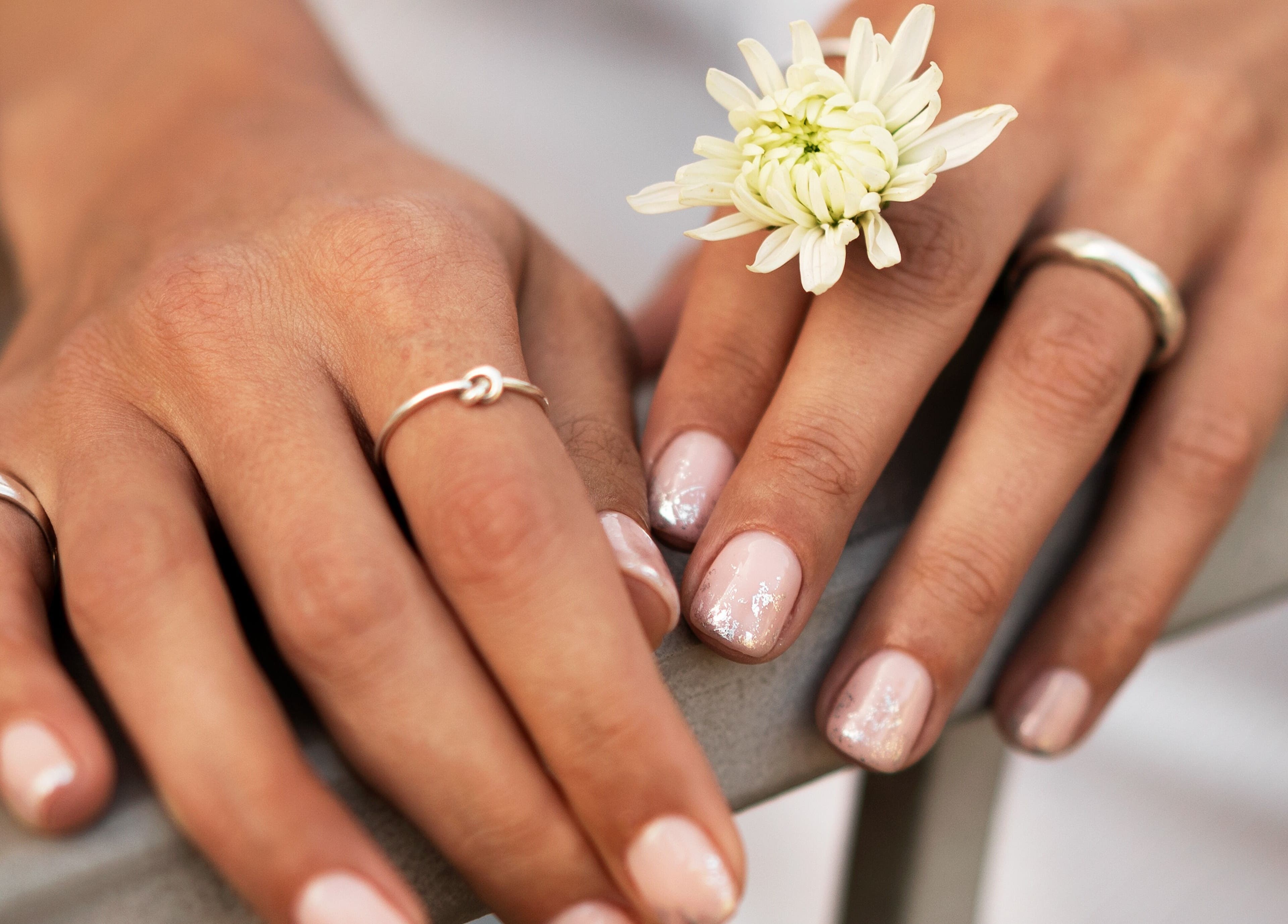 Elegant manicured hands with flowers at Auva Nails Home Service (Abu Dhabi), Abu Dhabi, AE.