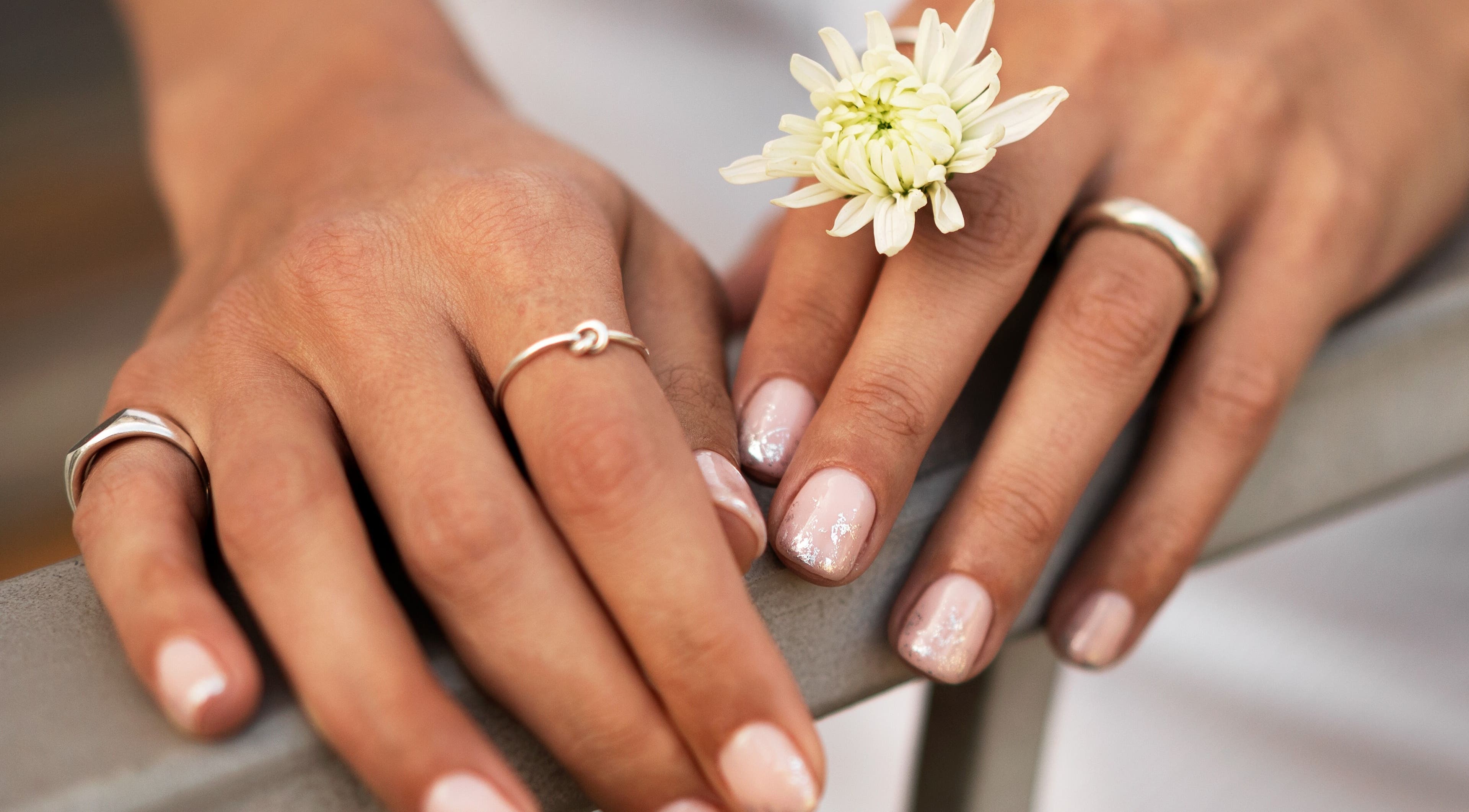 Elegant manicured hands with flowers at Auva Nails Home Service (Abu Dhabi), Abu Dhabi, AE.