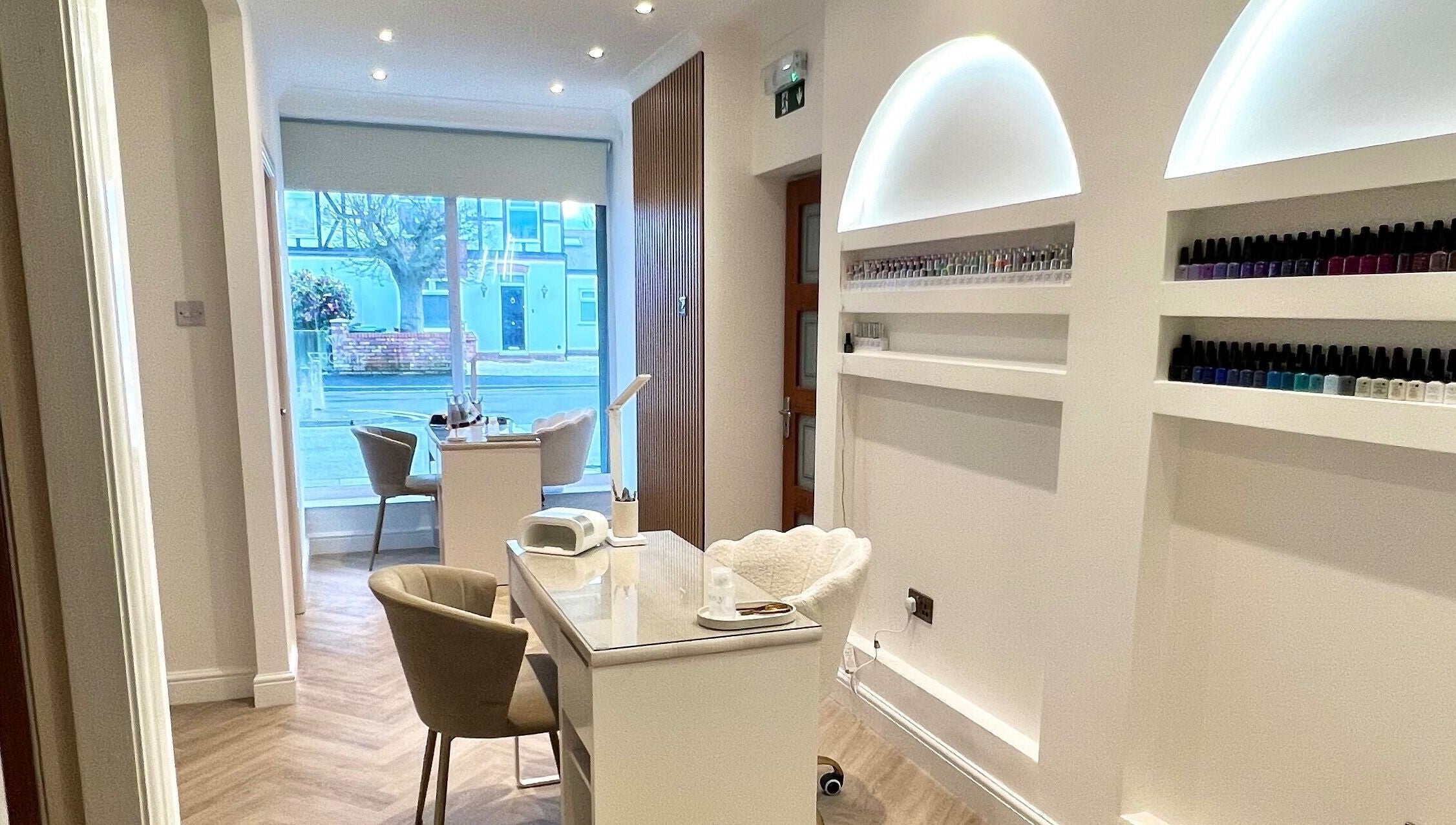 Modern nail treatment area at Pure Indulgence, Great Sankey, England, GB, showcasing stylish furniture and nail polish.