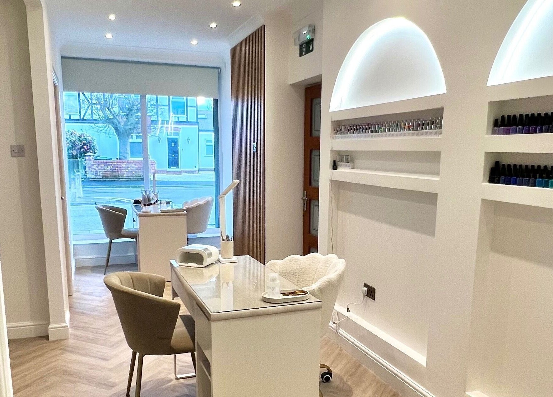 Modern nail treatment area at Pure Indulgence, Great Sankey, England, GB, showcasing stylish furniture and nail polish.