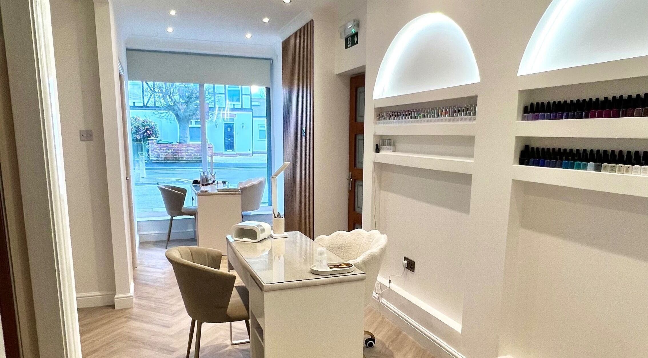 Modern nail treatment area at Pure Indulgence, Great Sankey, England, GB, showcasing stylish furniture and nail polish.
