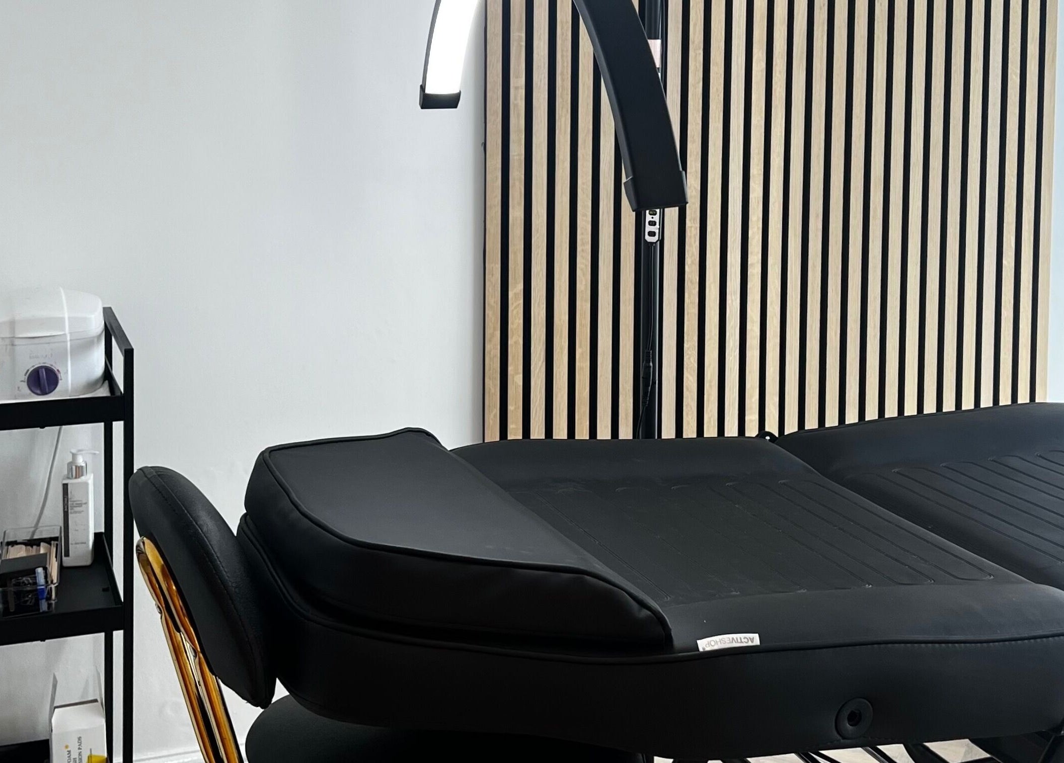 Pure Indulgence treatment room featuring a massage bed and products in Great Sankey, England, GB.