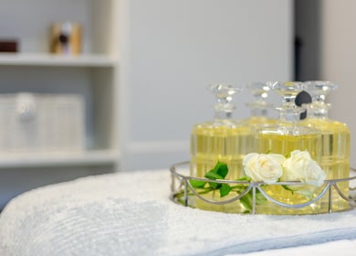 Essential oils and white roses at The House of Massage, London, England, GB, creating a serene atmosphere.