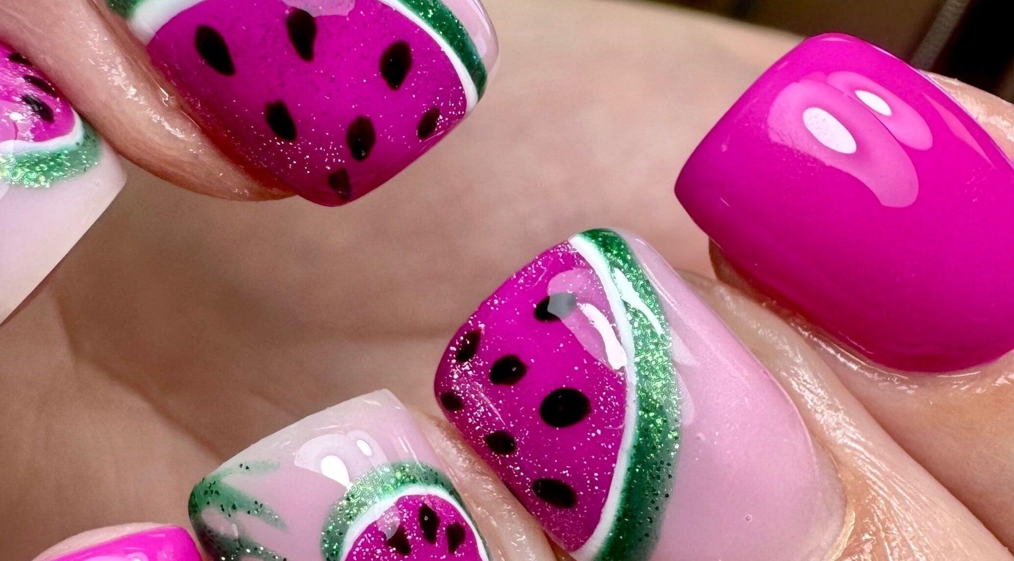 Creative watermelon-themed nail art at Em at The Parlour, Wirral, England, GB, showcasing vibrant colors.
