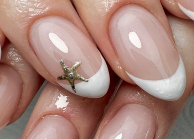 Elegant French manicure with starfish nail art at Em at The Parlour, Wirral, England, GB.