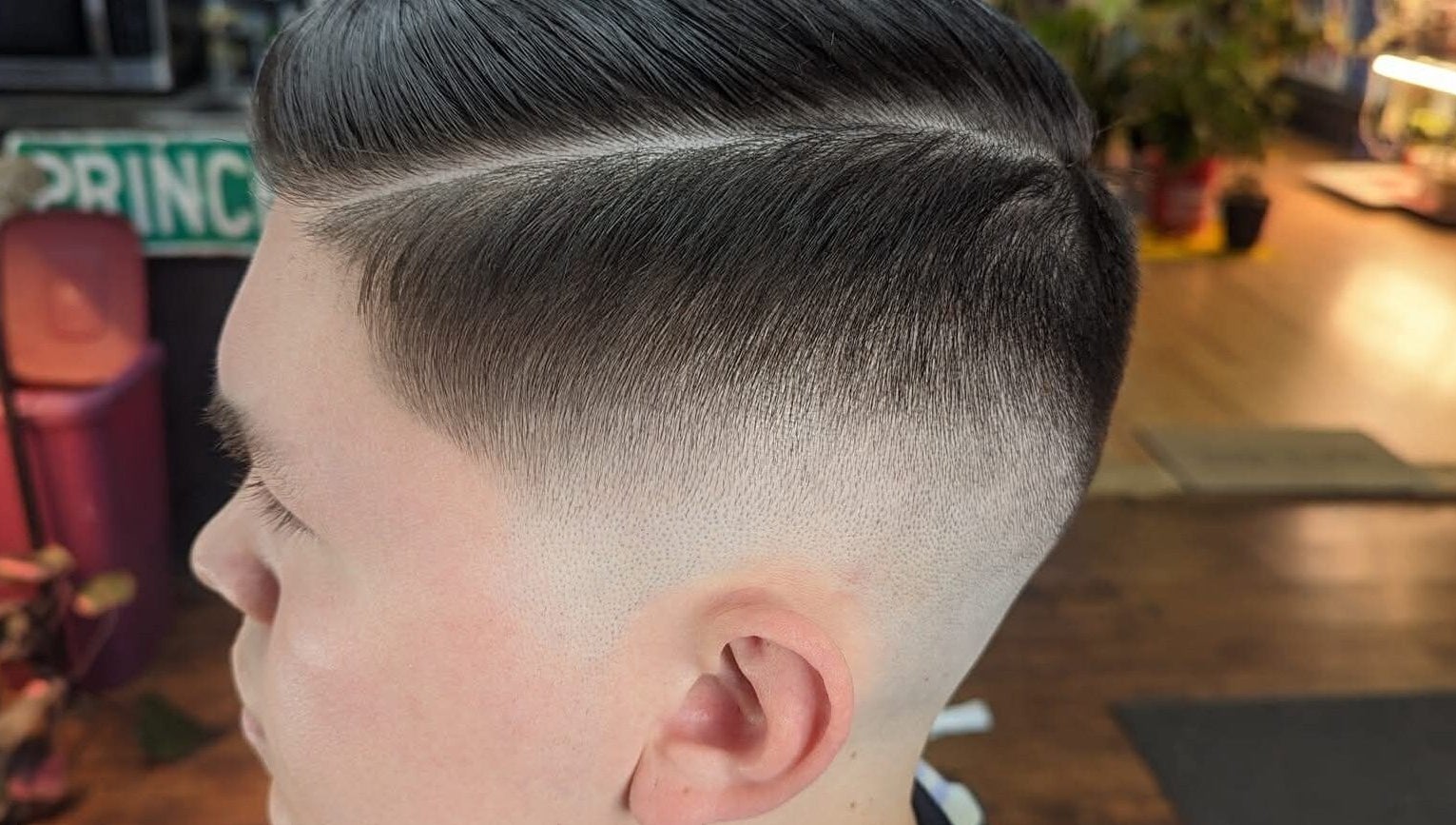 Close-up of stylish fade haircut at Uppercuts Barbershop LLC, Plainfield, Connecticut, US.