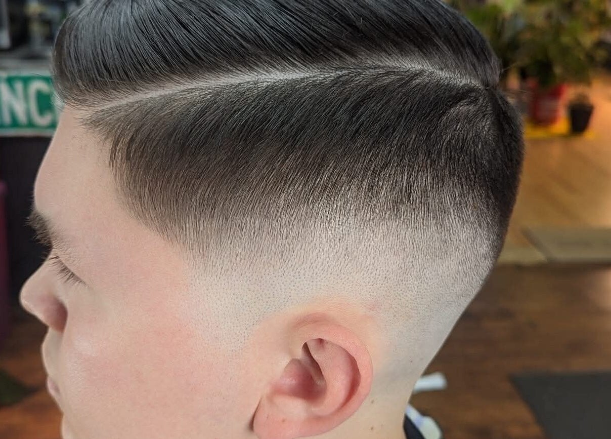 Close-up of stylish fade haircut at Uppercuts Barbershop LLC, Plainfield, Connecticut, US.
