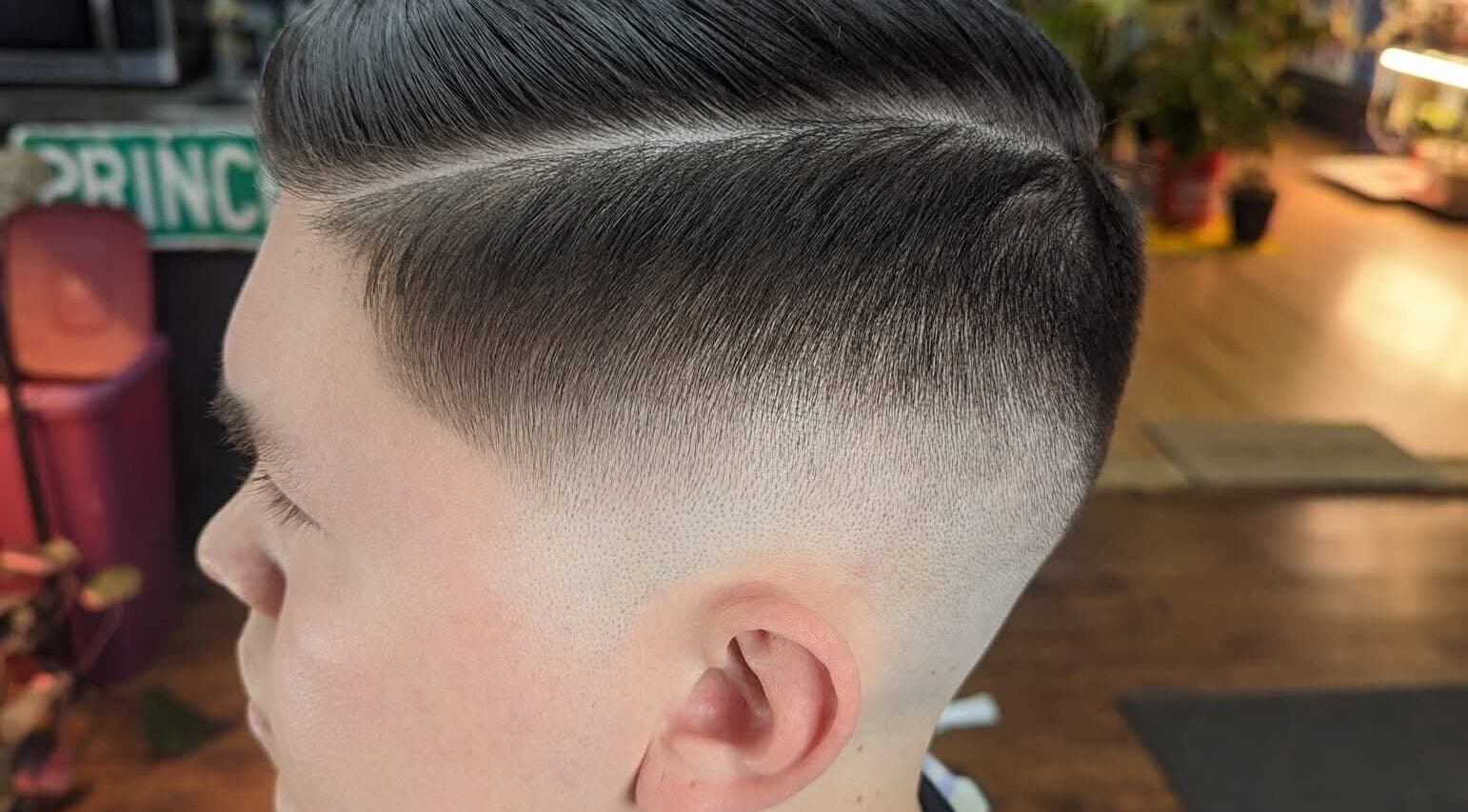 Close-up of stylish fade haircut at Uppercuts Barbershop LLC, Plainfield, Connecticut, US.
