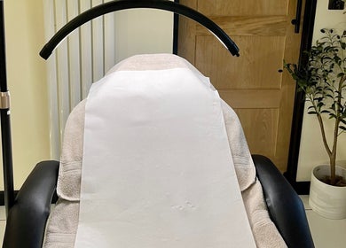 Treatment chair at Costa Skin Clinic, Alnwick, England, GB, with a serene light and decor.