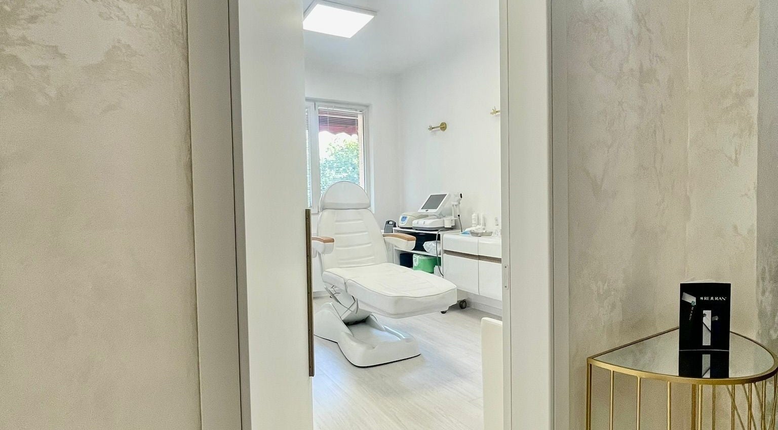 Dermalife Bulgaria treatment room in Sofia City Province, BG, featuring a modern white spa chair and equipment.