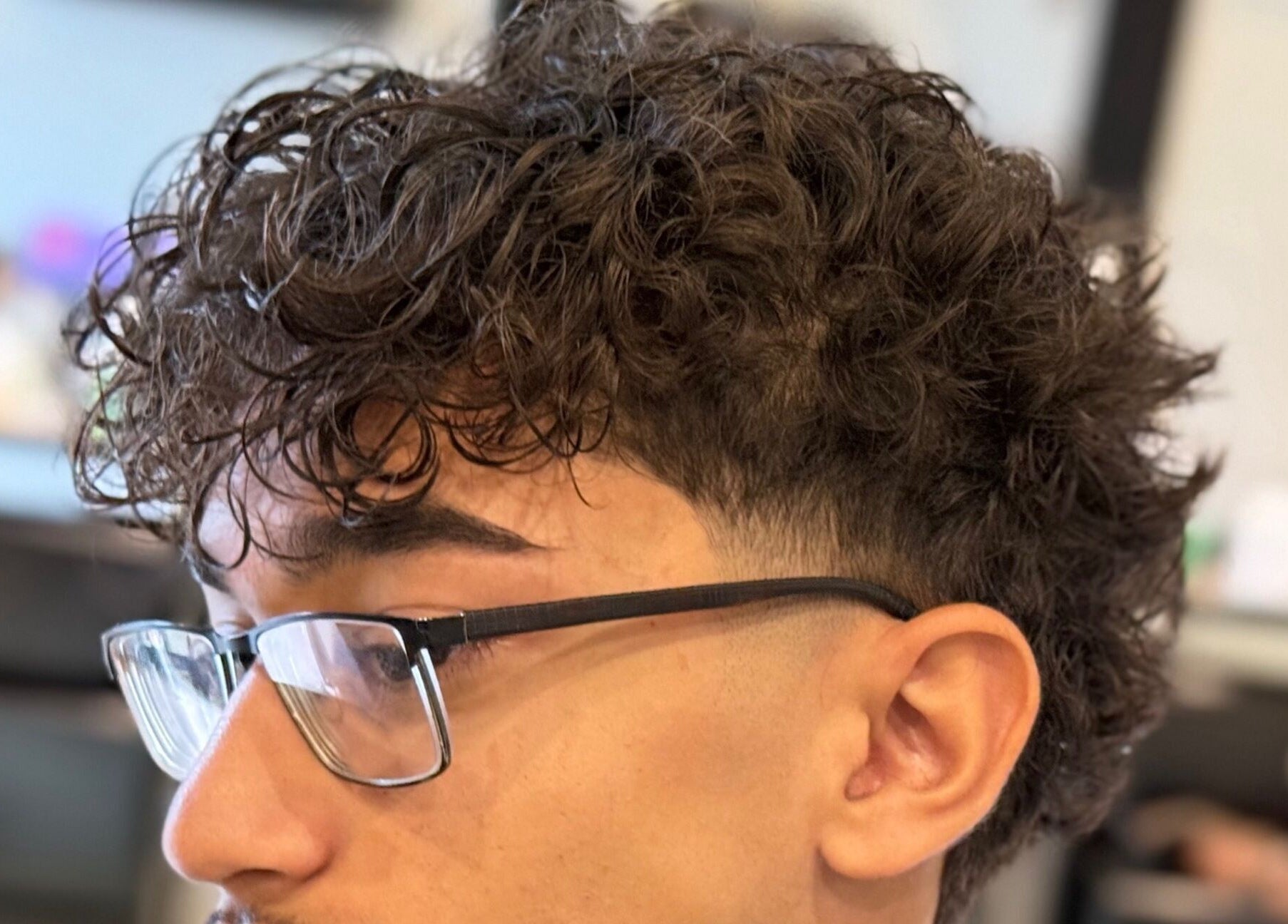 Close-up of a modern curly haircut at Bebert’s Cuts, San Fernando, San Fernando City Corporation, TT.