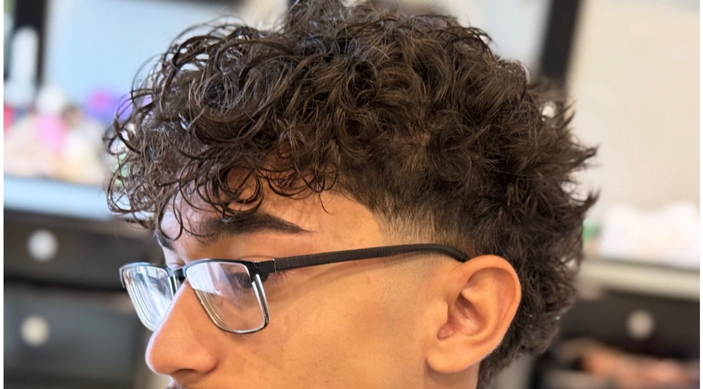 Close-up of a modern curly haircut at Bebert’s Cuts, San Fernando, San Fernando City Corporation, TT.
