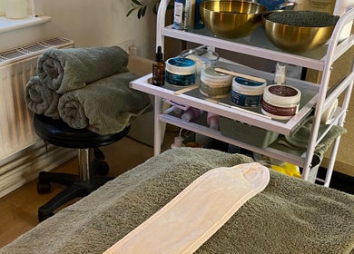 Cozy treatment setup at Serene Holistics And Beauty, Shrewsbury, England, GB with towels and spa products.